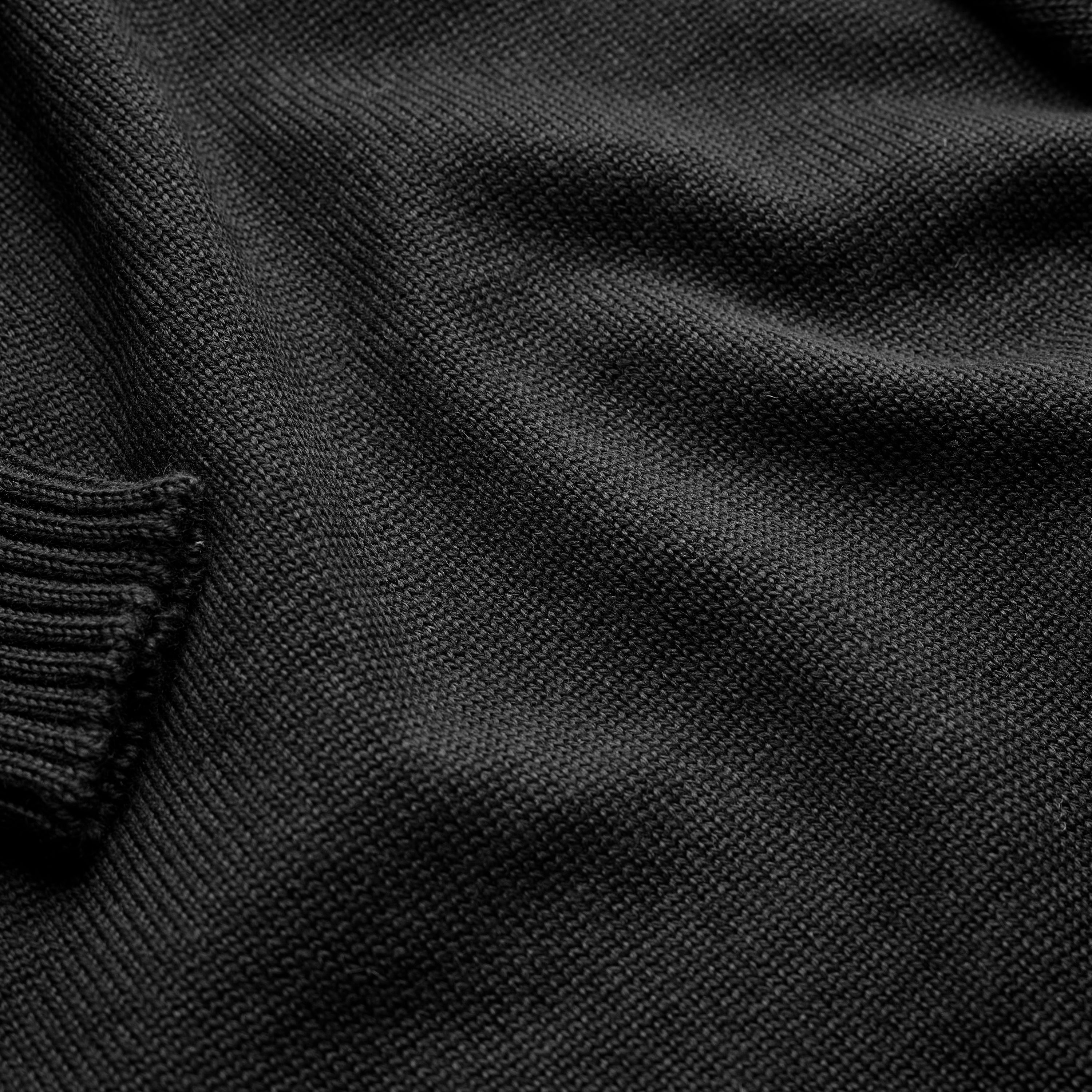 Close-up of the knit texture on the Guernsey Woollens x Fox roll neck in Midnight Black