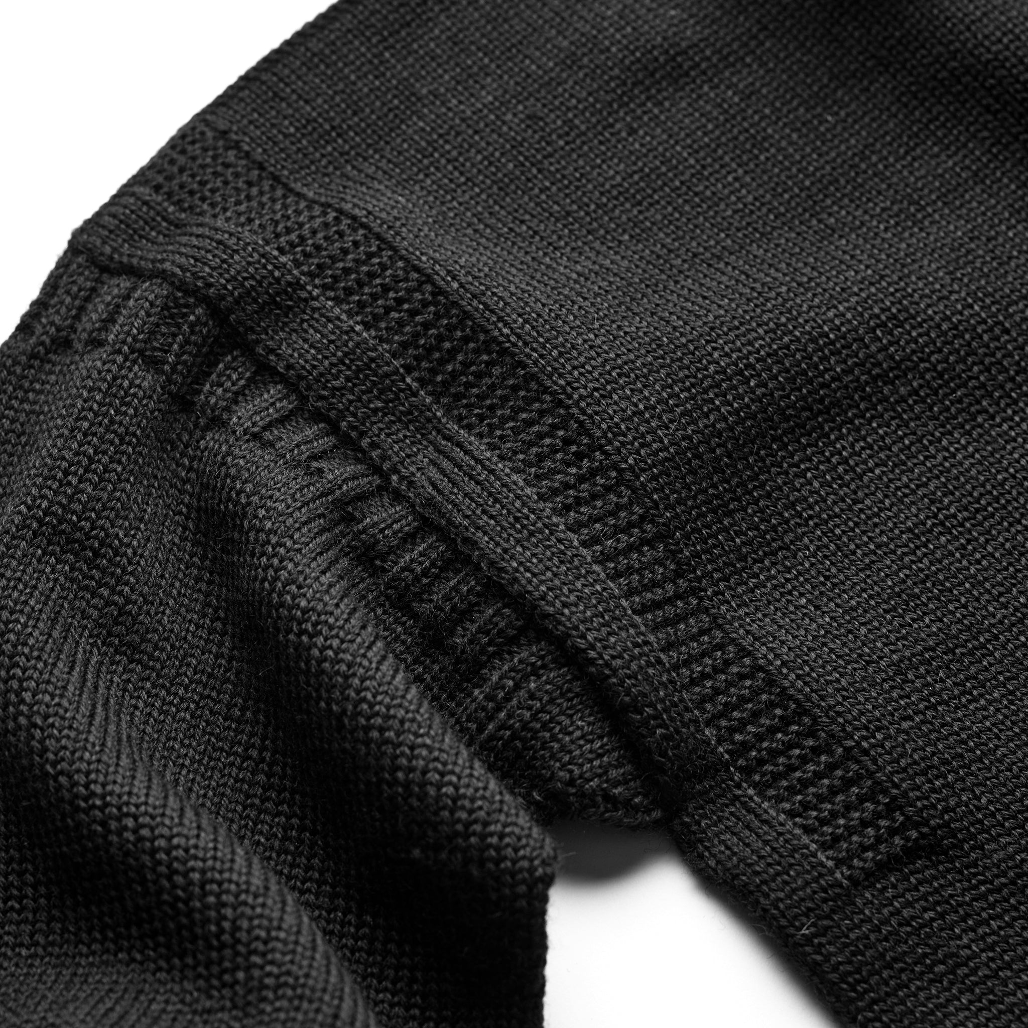 Shoulder and arm shaping detail on the Guernsey Woollens x Fox roll neck knit in Midnight Black
