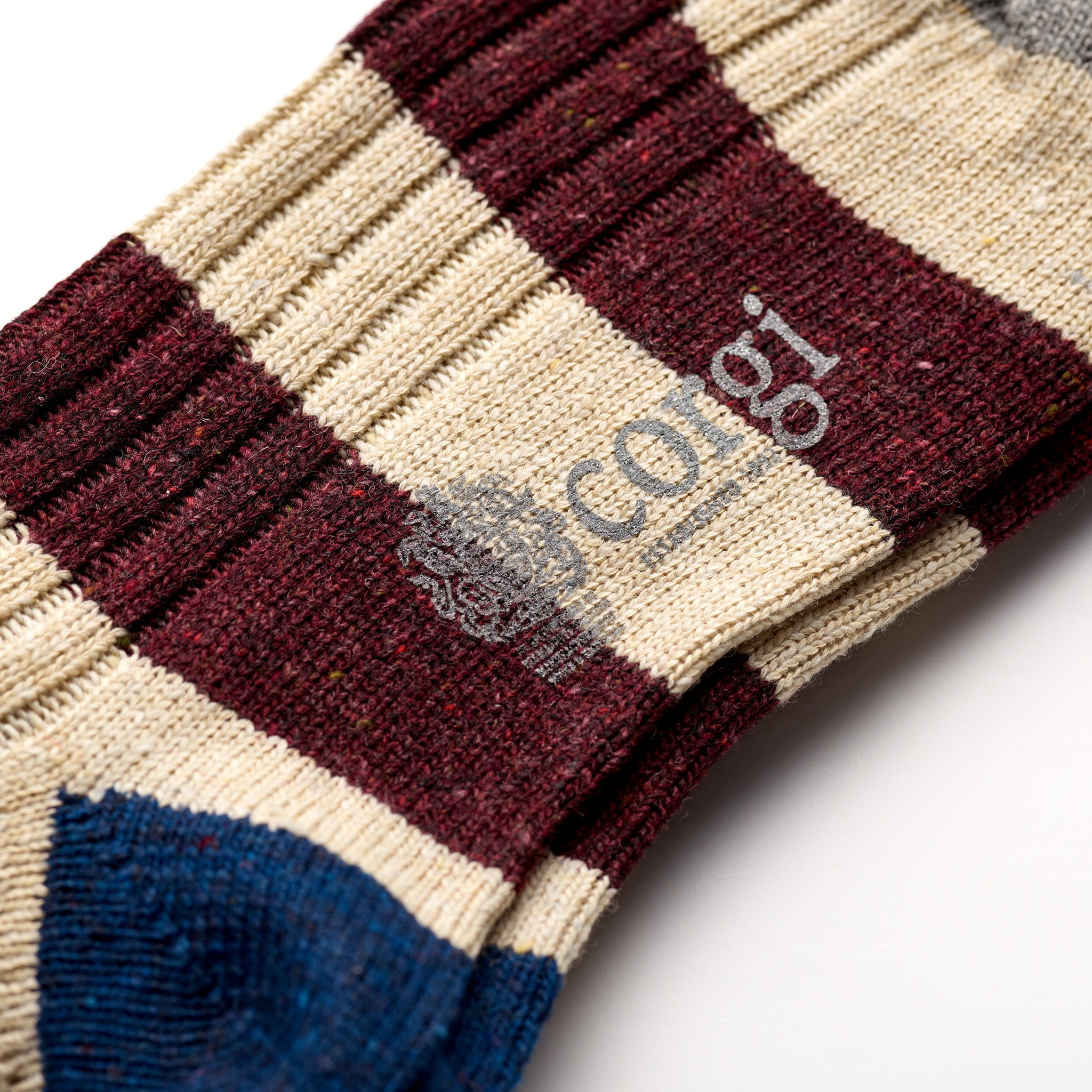 Corgi Heavyweight Donegal Rugby Striped Socks in Port foot logo and knit texture close-up