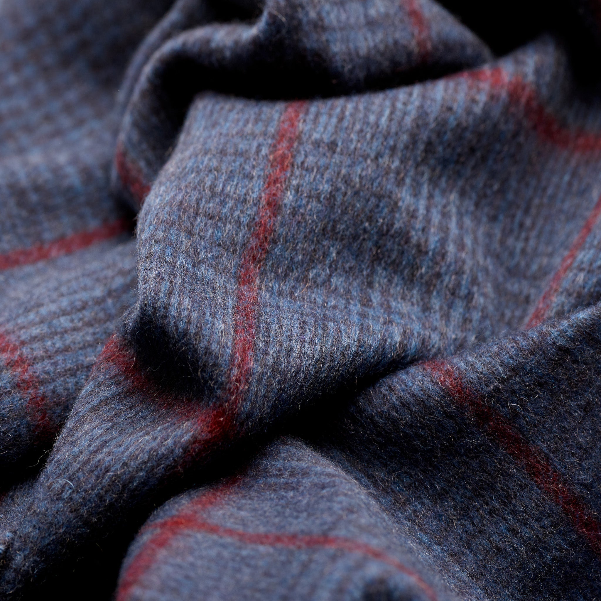 Close-up of navy heather cashmere with crimson check detail