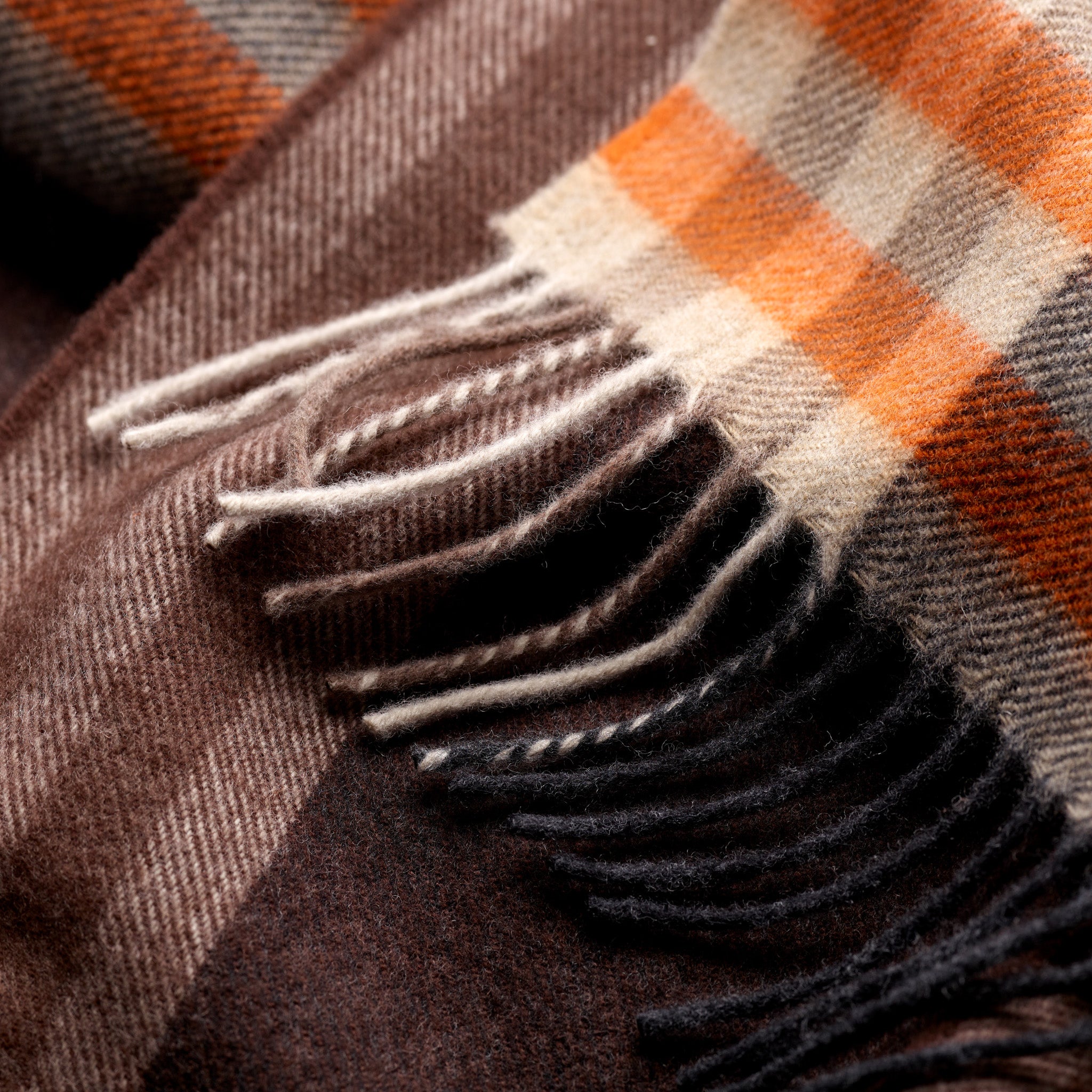 Close-up of brown and orange check pattern on Fox cashmere and wool scarf