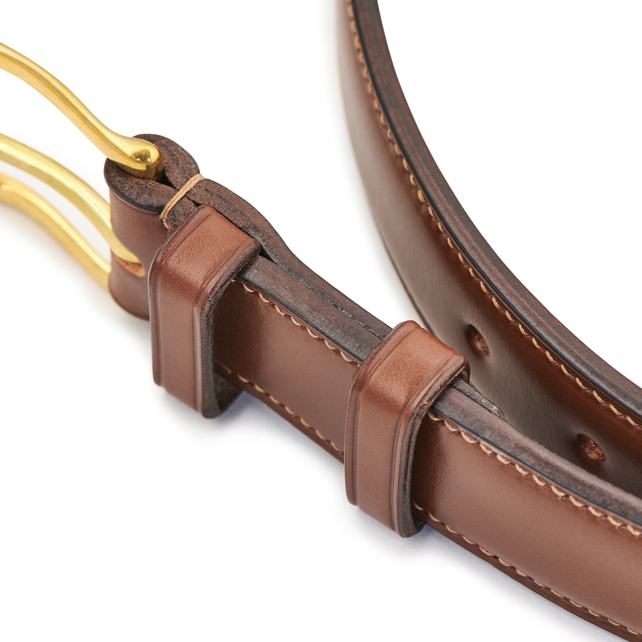 Close-up of raised leather profile and stitched edge on chestnut belt